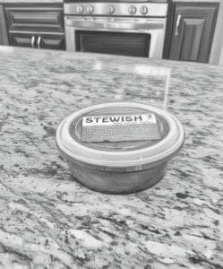 Container labeled "Stewish" on kitchen counter.