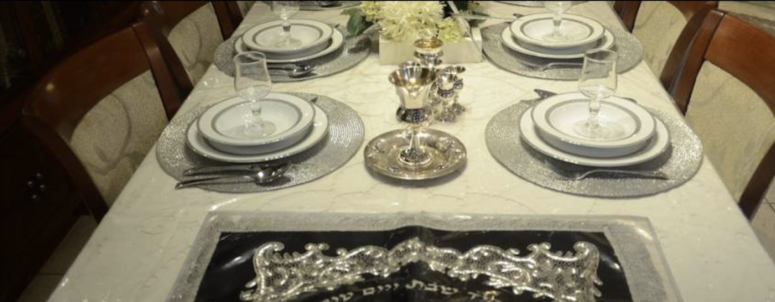 Elegant dining table set with fine china and silverware.
